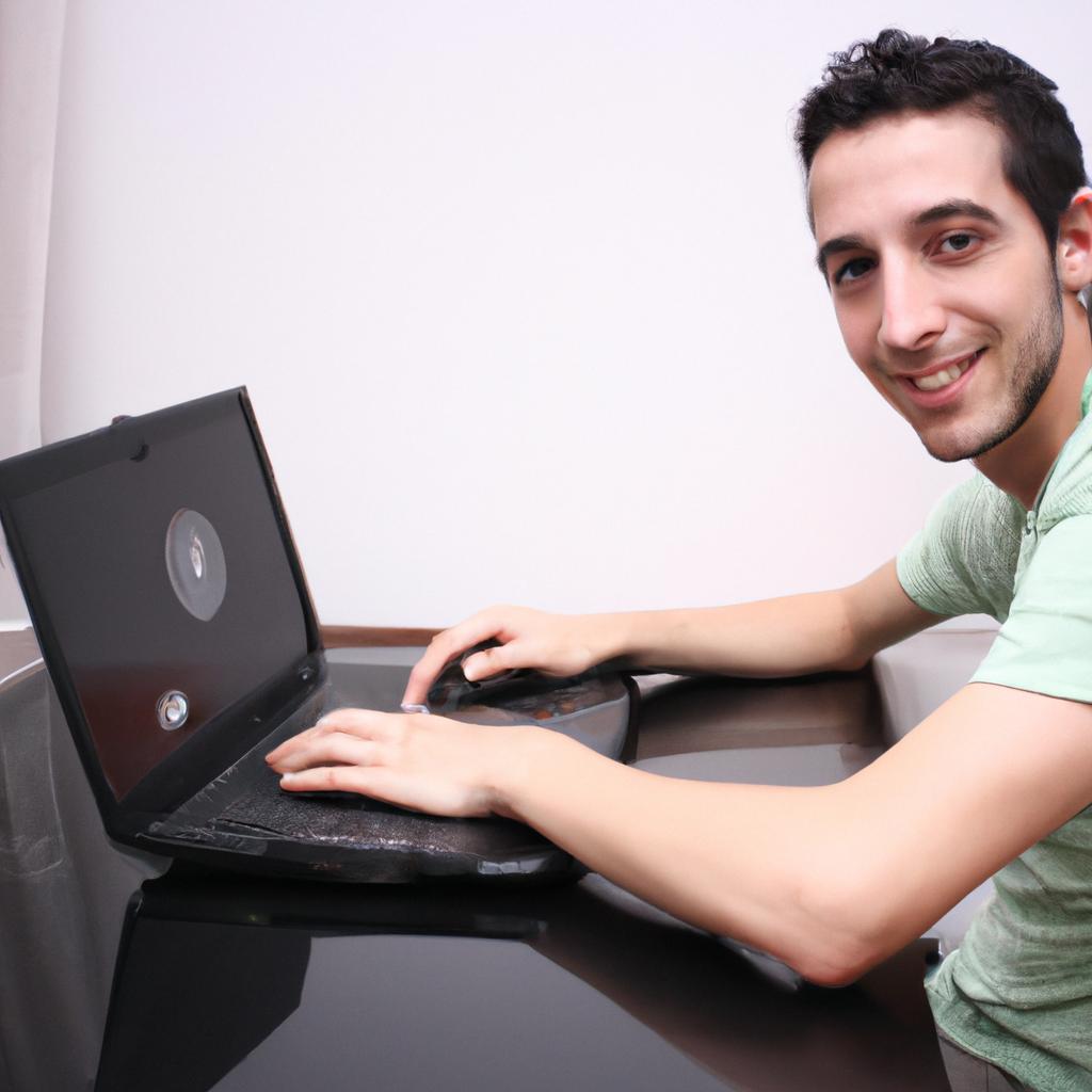 Person working on laptop, smiling